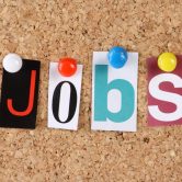 Letters for the word Jobs pinned to a bulletin board