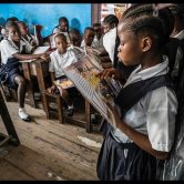 A student in a Monrovia public school reading a book aloud